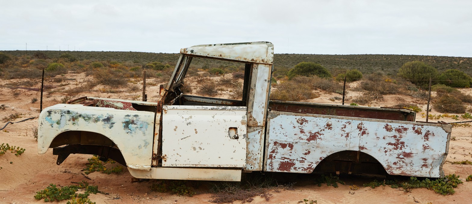 rusted pick up truck without tires, broken down